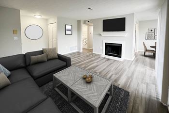 A living room with a couch and a coffee table and a fireplace